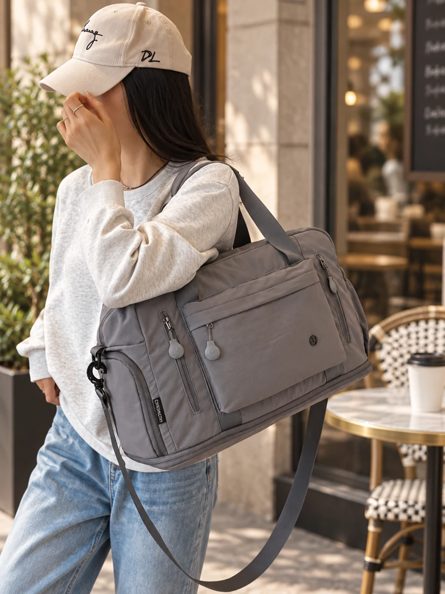 Grey shoulder bag styled at a city cafe